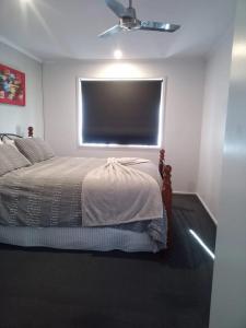 a bedroom with a bed and a large window at Golfside Getaway in Rosebud