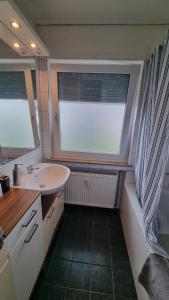 baño pequeño con lavabo y ventana en Ferienwohnung Friedenau, en Steinfurt