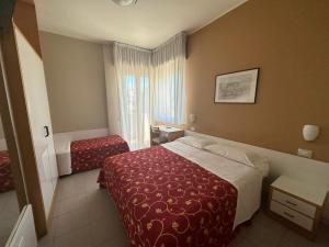 Postel nebo postele na pokoji v ubytování Hotel Junior