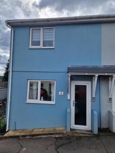 a blue house with a door and two windows at Charming 2 BedRoom Tredegar Gem. Sleeps 4 in Tredegar