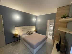 a bedroom with a large bed and a blue wall at Torino48 Guesthouse in Milan