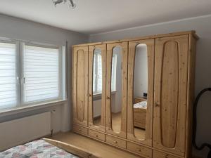 1 dormitorio con armario de madera con espejos en An der Glocke en Plettenberg