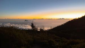 a view of the sun rising above the clouds at Ijen Transito 2 HOMESTAY in Ketapang