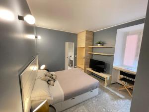 a small bedroom with a bed and a television at Torino48 Guesthouse in Milan