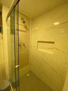 a bathroom with a shower with a glass door at Beach class Muro Alto 3202 in Porto De Galinhas