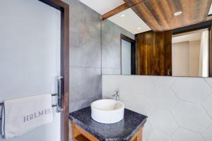 a bathroom with a white sink on a counter at Ultra Luxury Studio Apartment Elegant In Style in Gurgaon