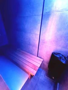a wooden bench in a room with a briefcase at Le Havre du Circuit / Triplex avec Sauna in Malmedy
