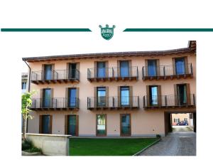 a building with balconies on the side of it at Trattoria Locanda Ai Tre Amici in Mortegliano