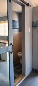 an open door to a bathroom with a toilet at Wylie Hall Guesthouse in Durban