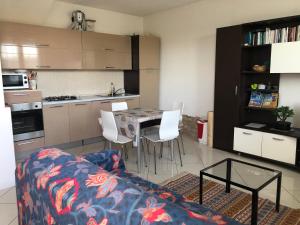 a living room with a couch and a table in a kitchen at Casa Ilaria in Armeno +51 photos