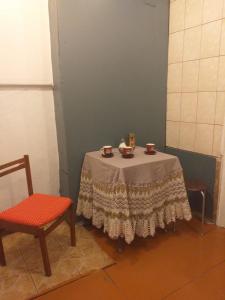 a small table with two cups and a chair at Talsu nov Kolka Kopmītne 1-18 in Kolka