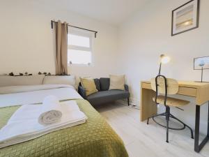 a bedroom with a bed and a desk and a chair at Leyton House - SleepyLodge in London