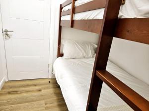 a couple of bunk beds in a room with a door at Wonderful Apartment in Wembley in London