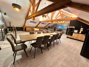 a dining room with a long table and chairs at loft 100m2 confort+. Chez Cédric et Jeza in Le Thillot