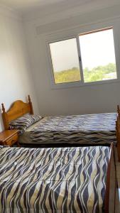 Voodi või voodid majutusasutuse Appartements Armonía Sea View toas