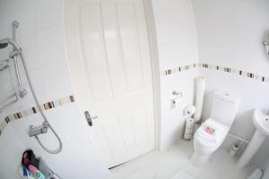 a white bathroom with a toilet and a sink at Luxurious Bedworth Exhall, House in Exhall