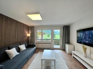 a living room with a couch and a table at Pure Comfort! Entire Apartment with Abundant Space near Zermatt in Täsch