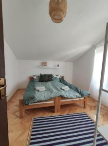 a bedroom with a bed with a green comforter at Park 2 Branka FREE PARKING in Vranje