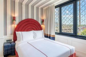 a hotel room with a bed and a window at Khai Karaköy in Istanbul