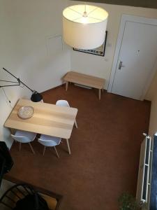 a room with a table and chairs and a lamp at Triplex près de la Grand-Place in Brussels