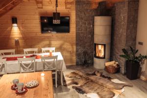 a living room with a table and a fireplace at Apartments Krvavec in Cerklje na Gorenjskem