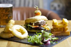 a sandwich with an apple on top of it and french fries at The Swan Hotel in Bibury