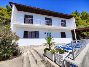 a villa with a swimming pool and a house at Robinson Olympos in Gdinj