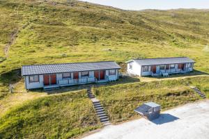 an aerial view of two houses on a hill at Arctic Lodging North Cape in Skarsvåg +20 photos