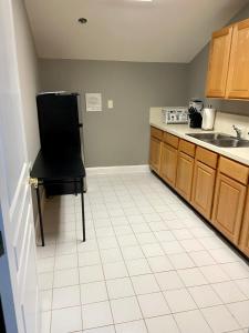 a kitchen with a black chair and a black refrigerator at Stafford Virginia Stay in Stafford