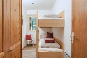 a room with two bunk beds and a door at ALPINE Appartement 208 Schladming by globboard in Schladming +18 photos