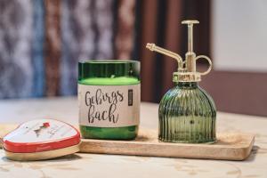 a table with a bottle of green soap and a candle at ALPINE Appartement 208 Schladming by globboard in Schladming