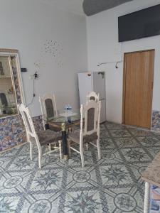 a dining room with a table and four chairs at Apartmá u Faltýnka in Brněnské Ivanovice