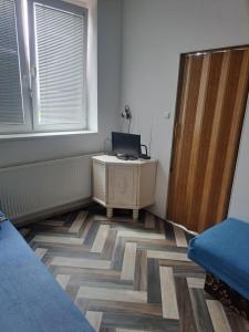 a room with a bed and a desk and a window at Apartmá u Faltýnka in Brněnské Ivanovice
