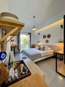 a large bedroom with a bed and a table at thēama Corfu in Marathias