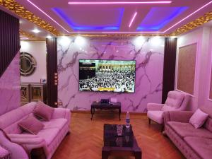 ein Wohnzimmer mit rosa Möbeln und einem TV an der Wand in der Unterkunft اللبيني فيصل شارع جمال الدين البنا فوق عمارة الرحمة فوق صيانة زانوسي الجيزة in Kairo