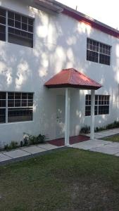 a white building with a red roof at Lynn's Place in Castries