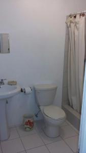 a bathroom with a toilet and a sink at Lynn's Place in Castries