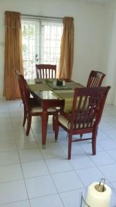 a dining room table with two chairs and a table and a table and chairsktop at Lynn's Place in Castries