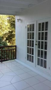 a white room with doors and a balcony at Lynn's Place in Castries