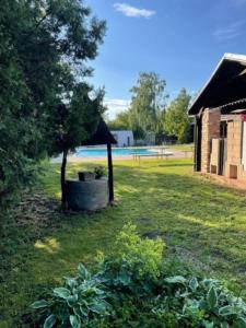 a garden with a tree and a building and a field at Kemp Josef Dubňany in Dubňany