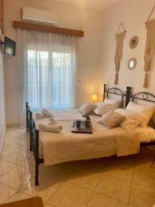 a bedroom with two beds and a window at Casa Amalia in Paradeísion