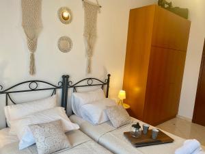 a bedroom with a bed with white pillows at Casa Amalia in Paradeísion