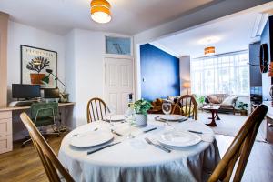 a dining room table with a white table cloth on it at Pass the Keys Cosy house on the seafront in Southend-on-Sea