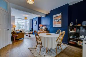 a dining room with a white table and chairs at Pass the Keys Cosy house on the seafront in Southend-on-Sea