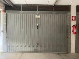 a metal garage door with a sign on it at Casa Linda in Fano