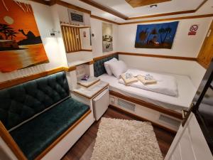 a small room with a bed and a couch at VIP Yacht Diving Club in Sharm El Sheikh