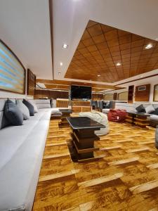 a room with a couch and a tv on a boat at VIP Yacht Diving Club in Sharm El Sheikh
