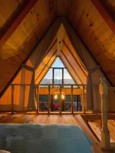 a room with a large window in a roof at Green Luxury Bungalovs in Pazar