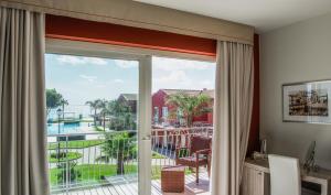 a room with a sliding glass door with a view of a pool at Hotel Valeria Del Mar in Belvedere Marittimo