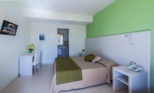 a small bedroom with a bed and a table at Hotel Valeria Del Mar in Belvedere Marittimo +27 photos